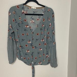 Button up long sleeve top. Tie at the bottom with elastic end at sleeves.